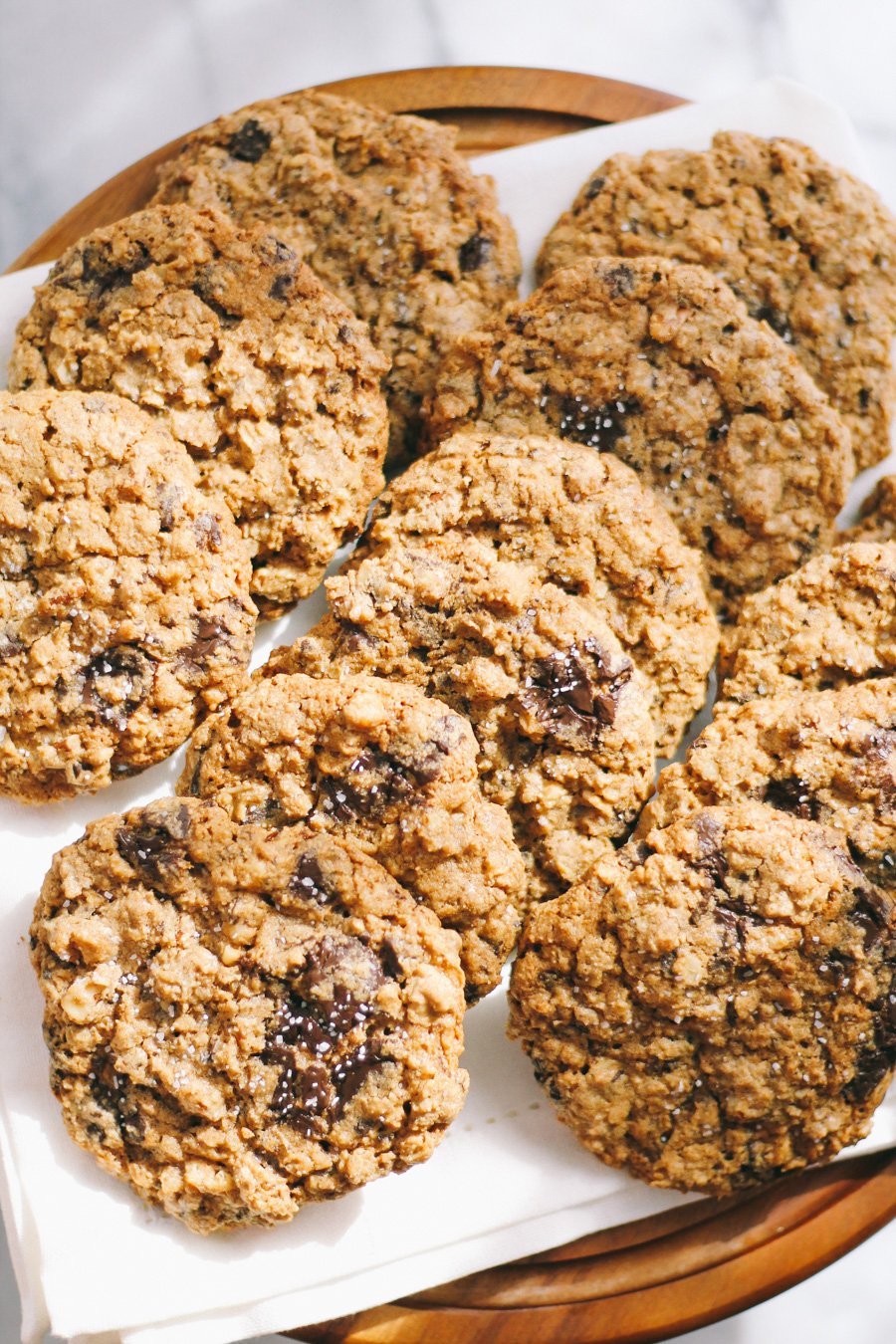 dark chocolate chunk oatmeal cookies with walnuts, pecans, & sea salt via playswellwithbutter | not your average chocolate chip cookie, dark chocolate chunk oatmeal cookies have the perfect crunchy yet chewy texture & are loaded with rich chunks of dark chocolate, walnuts, & pecans. finished with just a kiss of sea salt, these perfect cookies will have you coming back for more!