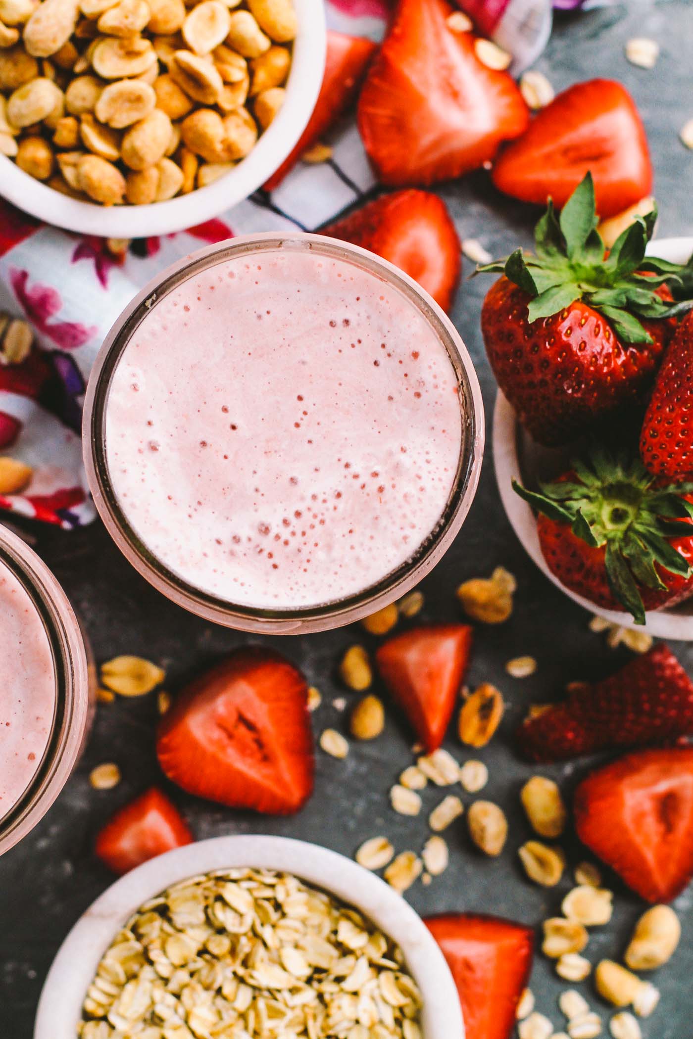 a creamy, delicious smoothie recipe for an easy, healthy breakfast for any busy weekday mornings! these peanut butter & jelly strawberry smoothies are loaded with strawberries, peanut butter, & oats to keep you full until lunchtime. | smoothie, healthy smoothie, protein shake, healthy breakfast, smoothie pack, gluten free, vegan, iifym |
