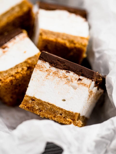 everyone’s childhood summer favorite gets a major update in this recipe for s’mores bars. these s’mores bars sandwich a thick layer of fluffy homemade vanilla bean marshmallow in between graham cracker crust & salted dark chocolate ganache. your favorite campfire treat will never be the same!
