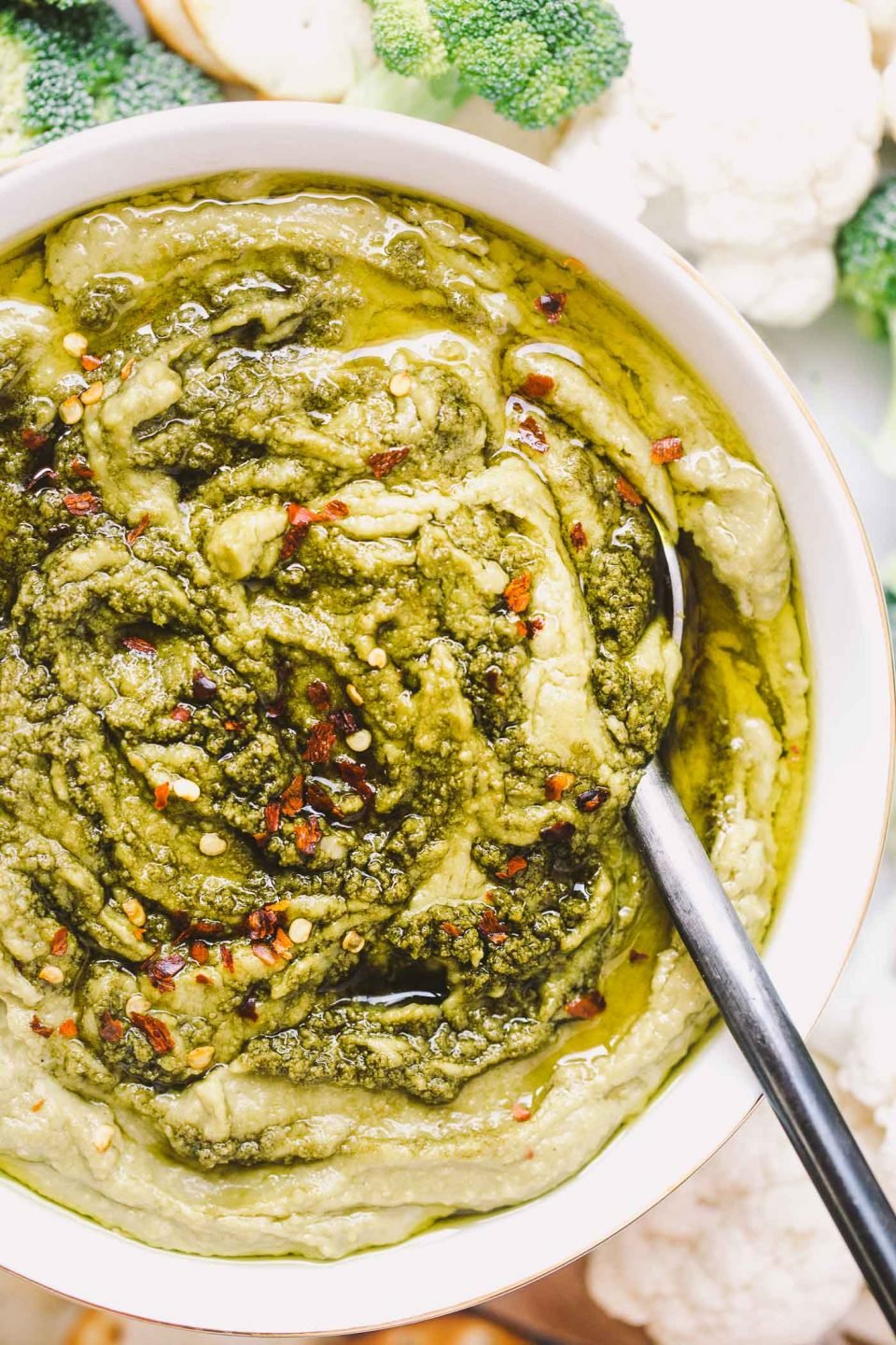 a creamy, dreamy, totally addictive white bean hummus loaded with the bright flavors of pesto & lemon. perfect for healthy end-of-summer snacking, an easy appetizer to bring to potlucks, or the perfect snack to bring to a football party!