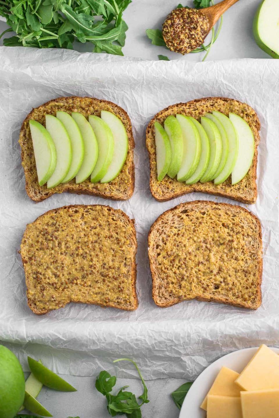 autumn grilled cheese sandwiches stuffed with fall flavor! hearty whole-grain bread slathered in whole grain mustard & sandwiched around melty gouda, smoked turkey, & crisp granny smith apples. the only thing missing is a big dunk into a bowl of tomato soup! #playswellwithbutter #comfortfood #grilledcheese #grannysmith
