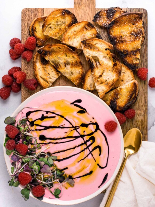 tart and juicy fresh raspberries whipped into creamy goat cheese with honey to make this whipped raspberry goat cheese spread. topped with a drizzle of reduced balsamic and served up with grilled bread, this whipped raspberry goat cheese spread is the perfect easy & elegant appetizer for any dinner party or girls night! #easyappetizerrecipe #rasberryrecipe #goatcheesespread #girlsnightidea #girlsnightrecipe #playswellwithbutter