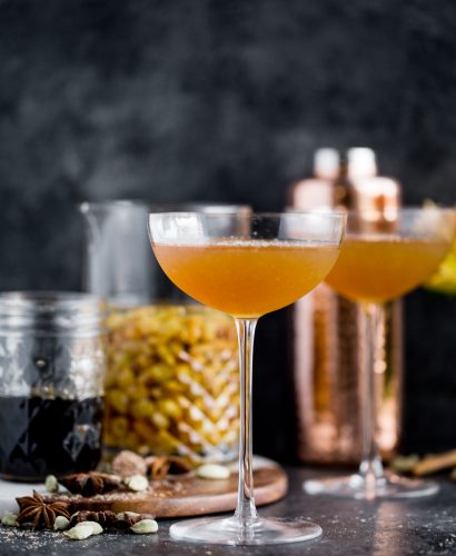a cozy chai cocktail with golden raisin-infused spiced rum & homemade vanilla chai simple syrup. this chai cocktail is just as perfect for a cozy date night in as it is for celebrating with friends & loved ones this winter season. the perfect cozy winter nightcap. cheers! #playswellwithbutter #chai #rum #hygge #datenightathome #cocktail #cocktailrecipe #wintercocktail #winterdrink #cozycocktail #cozy