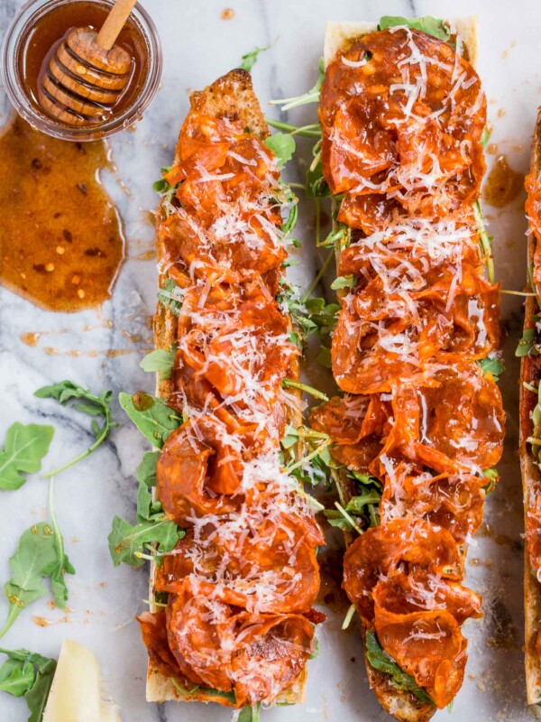 easy chorizo french breads with manchego, fig spread, & harissa, & covered in big fat drizzles of homemade spicy paprika honey. an easy & elegant appetizer! an easy & elegant appetizer or snack, perfect for holiday entertaining! #playswellwithbutter #chorizo #harissa #manchego #holidayparty #cocktailparty #appetizer