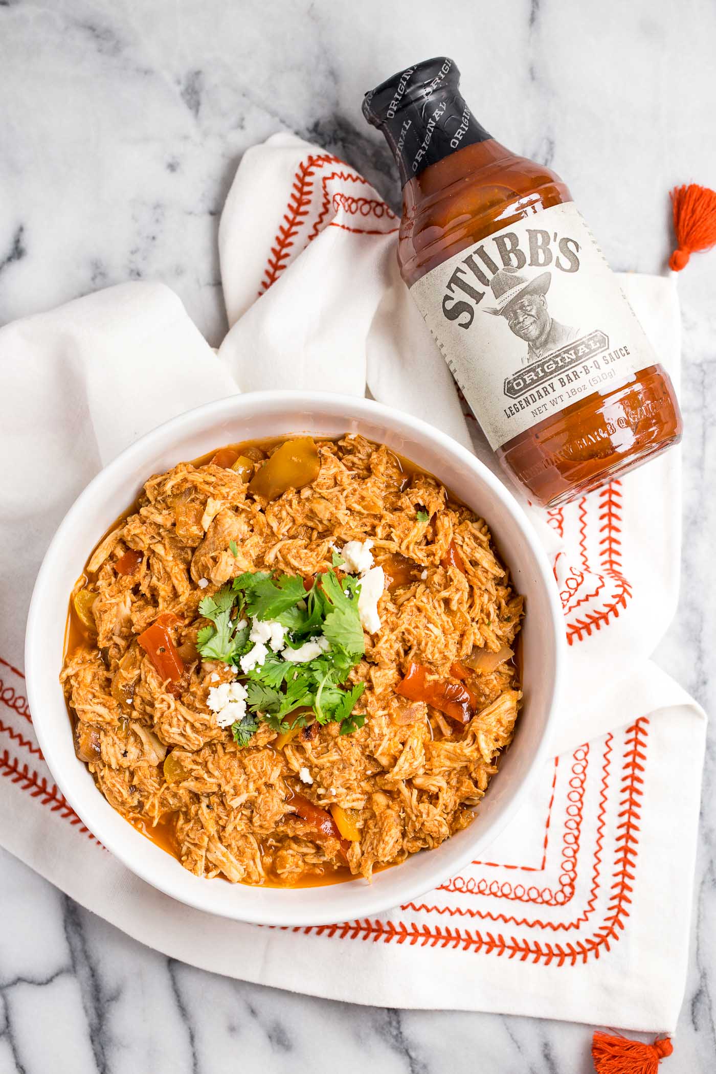 not only is slow cooker shredded bbq chicken an easy & healthy weeknight dinner, it’s SUPER versatile. here are 3 of my favorite ways to use it (without eating the same thing all week long!) - shredded bbq chicken stuffed sweet potatoes, shredded bbq chicken meal prep bowls, & shredded bbq chicken sliders perfect for game day! #playswellwithbutter #slowcookerrecipe #crockpotrecipe #healthydinnerrecipe #easydinnerrecipe #bbqchicken #barbecuechicken