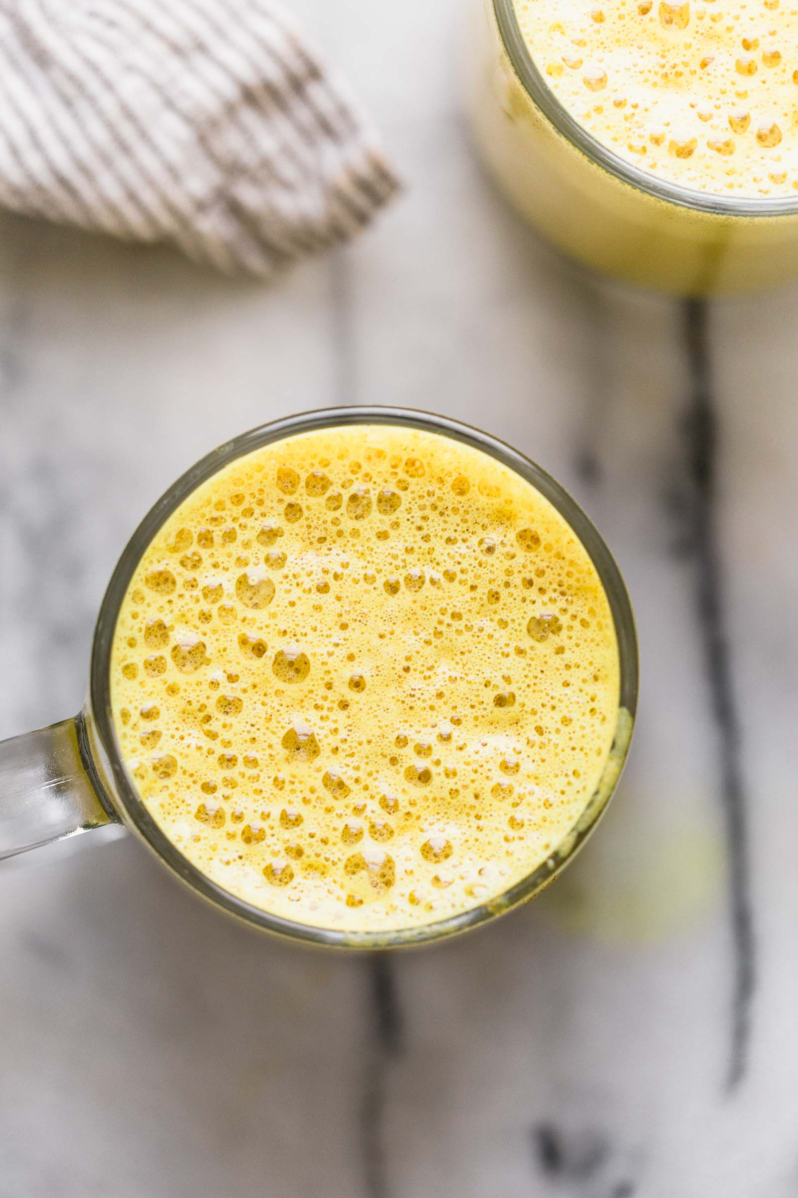 an easy golden turmeric latte recipe that’s just as delicious as it is beautiful! this easy golden turmeric latte is loaded with the warm flavors, antioxidants and anti-inflammatory benefits of turmeric, ginger, and cinnamon. great for a calming morning drink, or an afternoon pick-me-up! #goldenlatte #turmericlatte #healthycoffeerecipe #healthybreakfast #homemadelatte #playswellwithbutter