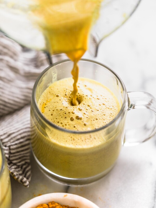 an easy golden turmeric latte recipe that’s just as delicious as it is beautiful! this easy golden turmeric latte is loaded with the warm flavors, antioxidants and anti-inflammatory benefits of turmeric, ginger, and cinnamon. great for a calming morning drink, or an afternoon pick-me-up! #goldenlatte #turmericlatte #healthycoffeerecipe #healthybreakfast #homemadelatte #playswellwithbutter