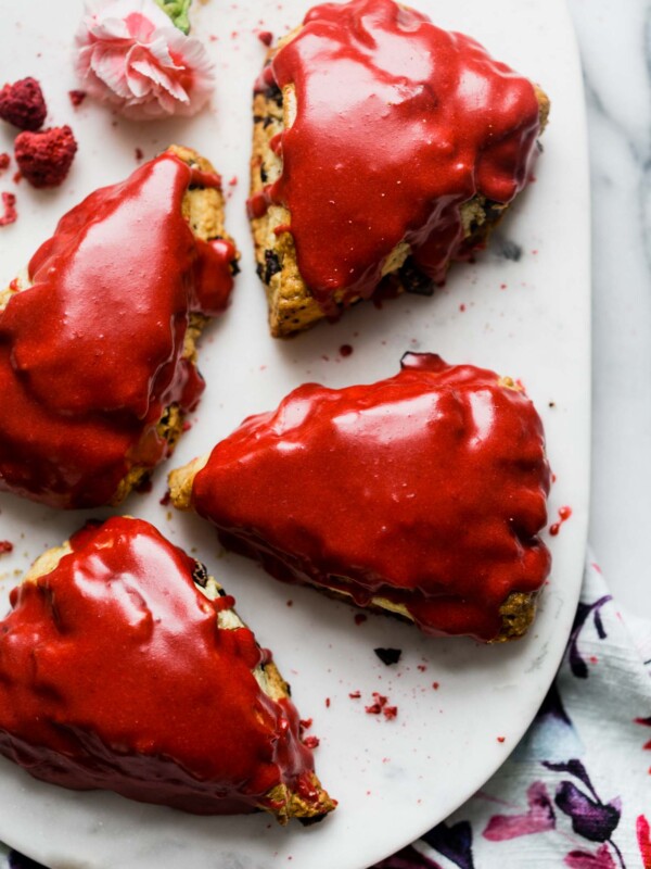 tender & flaky scones bursting with dark chocolate chunks & topped with the perfect raspberry glaze. raspberry dark chocolate chunk scones are perfect for galentine’s day, a wedding shower, baby shower, or any ladies’ brunch! #scones #sconerecipe #galentinesday #brunchrecipe #playswellwithbutter