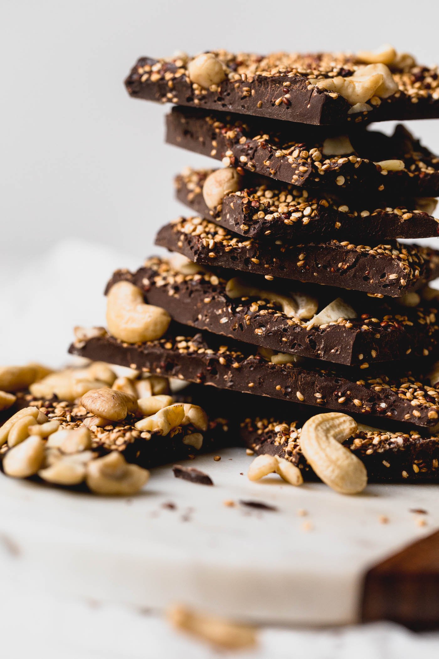 a simple & healthy three-ingredient dark chocolate bark recipe with toasted quinoa folded throughout a thick layer of dark chocolate and topped with cashews. this superfood dark chocolate bark has it all - plant-based protein, antioxidants, & healthy fats - what more could you want out of a healthy little on-the-go snack or dessert? #darkchocolatebark #chocolatebarkrecipe #healthychocolatebark #healthydessert #superfoodsnacks #healthysnack #toastedquinoa #cashews #darkchocolate