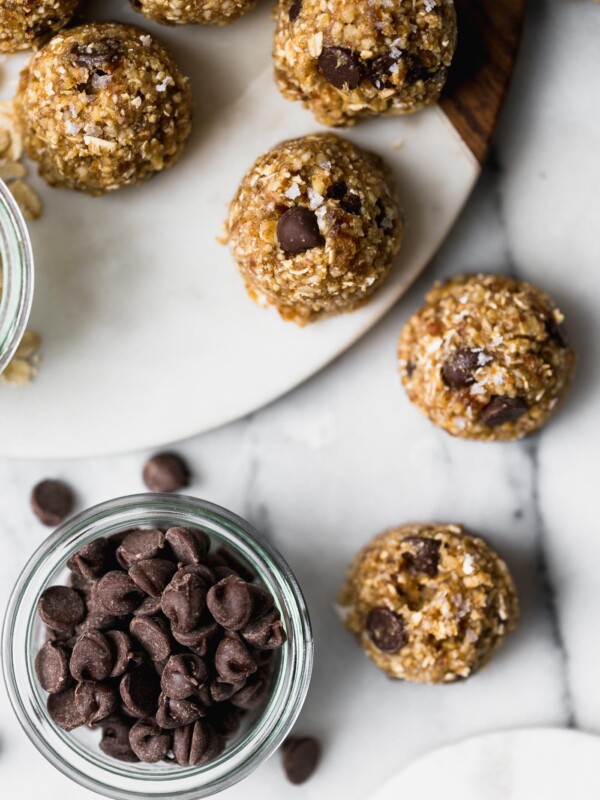 chocolate chip banana bread bliss balls are an easy & totally wholesome snack! inspired by chocolate chip banana bread, but in the form of a healthy, raw energy bite, these chocolate chip banana bread bliss balls are loaded with dates, cashews, almonds, walnuts, and banana. #playswellwithbutter #blissballs #energybites #healthysnack #healthydessert #healthyrecipe #bananabreadbites #bananabread