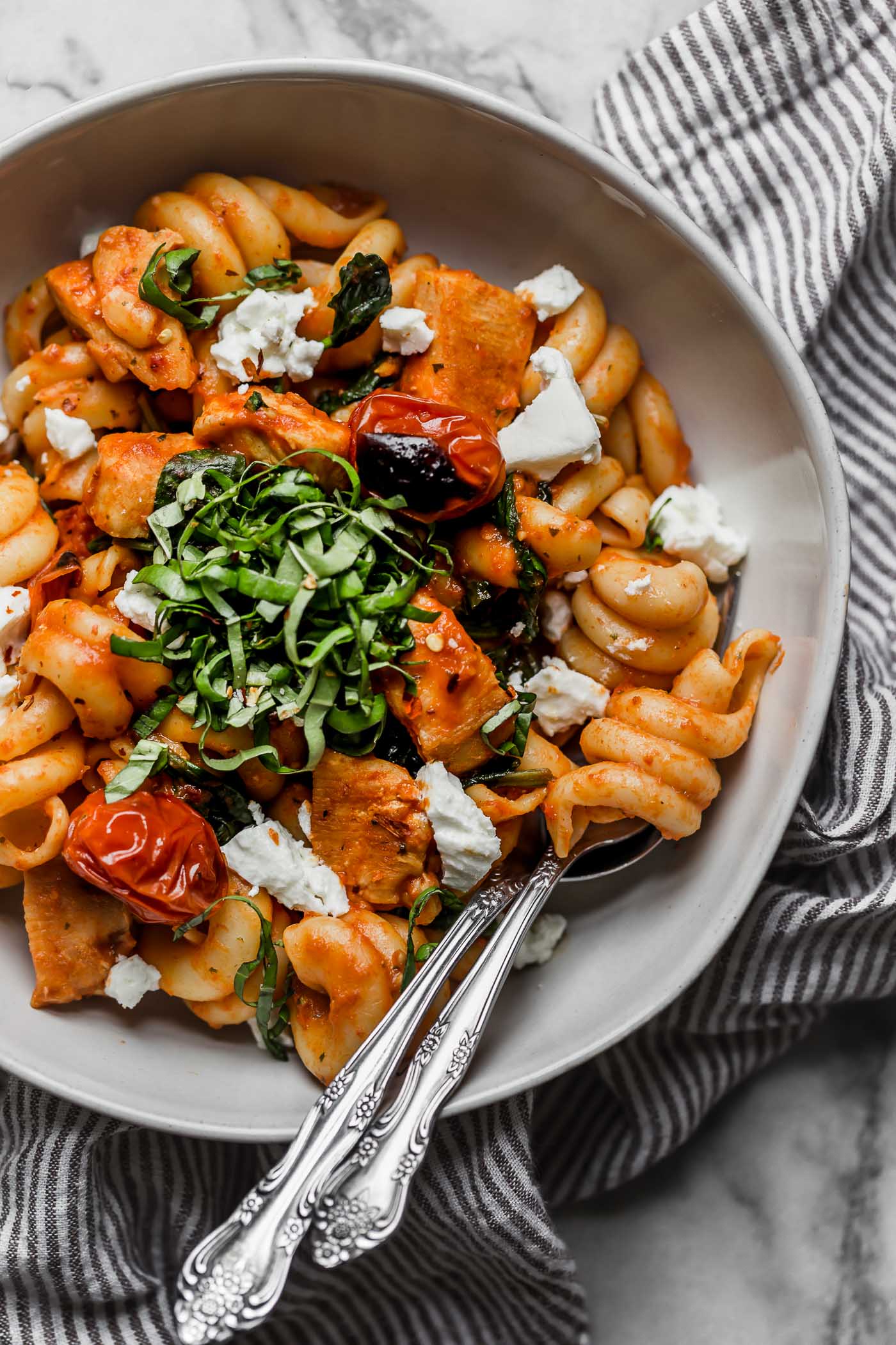 date night pasta pomodoro with chicken & goat cheese is the perfect easy pasta dinner recipe! made with chicken, spinach, goat cheese, and a homemade roasted red pepper pomodoro sauce, this pasta pomodoro with chicken & goat cheese is on your table in 25 minutes or less, tastes totally fresh, & is perfect for date night! #playswellwithbutter #easypastarecipe #pastapomodoro #pastadinner #italianrecipe