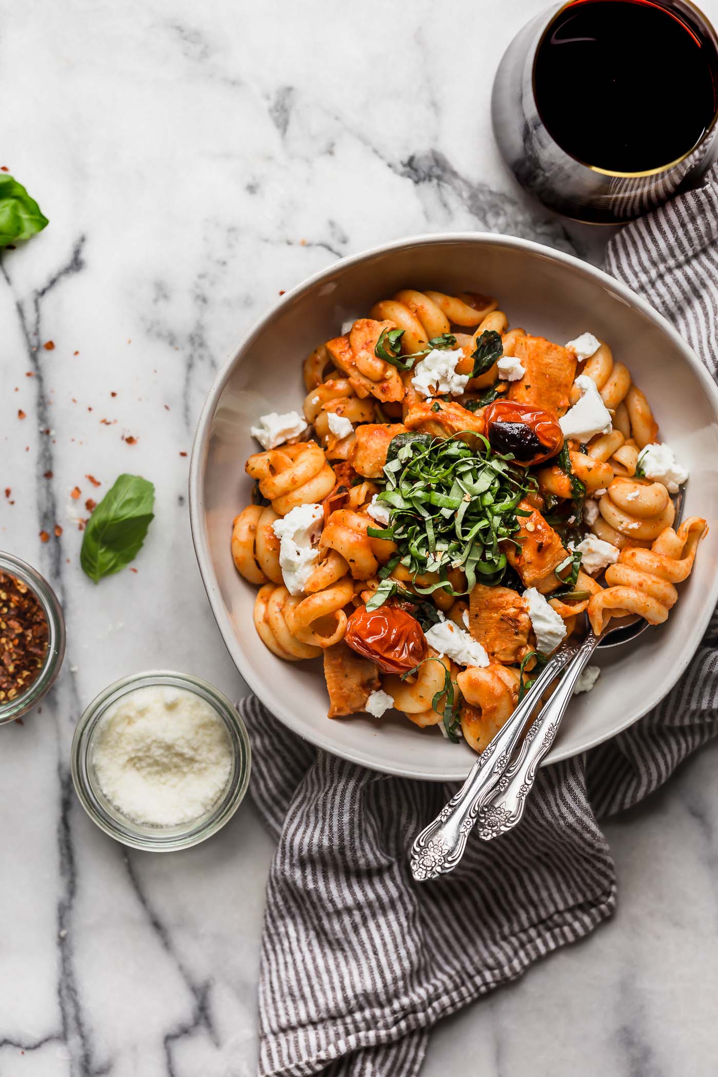 date night pasta pomodoro with chicken & goat cheese is the perfect easy pasta dinner recipe! made with chicken, spinach, goat cheese, and a homemade roasted red pepper pomodoro sauce, this pasta pomodoro with chicken & goat cheese is on your table in 25 minutes or less, tastes totally fresh, & is perfect for date night! #playswellwithbutter #easypastarecipe #pastapomodoro #pastadinner #italianrecipe