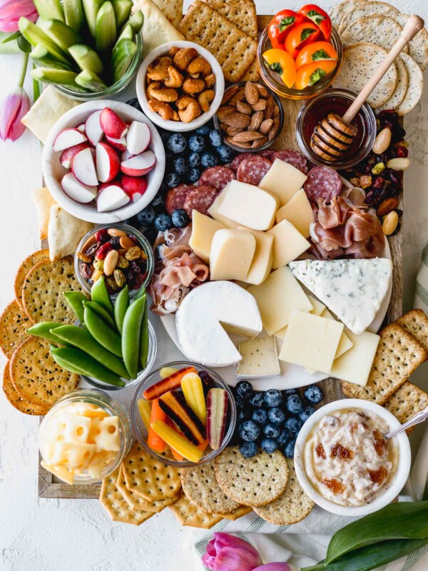 building a stunning & delicious ultimate cheese board on a budget couldn’t be easier when you take advantage of the low prices at aldi! this ultimate aldi cheese board is inspired by springtime with a variety of cheeses, crackers, veggies, & nuts, & is perfect for any spring celebration - mother’s day, father’s day, graduation parties, bridal showers, or spring brunches! #playswellwithbutter #cheeseboard #howtomakeacheeseboard #easycheeseboard #cheeseboardideas #springcheeseboard #bridalshoweridea #appetizeridea #appetizerrecipe #aldirecipe #whattobuyataldi #aldifinds
