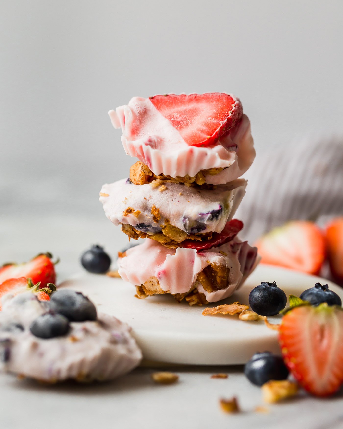 easy & healthy frozen yogurt bites call for only 5 ingredients and 10 minutes of active prep time! with wholesome ingredients like greek yogurt, fruit, honey, and your favorite granola, these frozen yogurt bites are as healthy as they are delicious - the best little treat to keep in your freezer this summer! #playswellwithbutter #frozenyogurtbites #frozenyogurt #greekyogurt #healthysnack #glutenfreerecipe #summertreats #summerdesserts