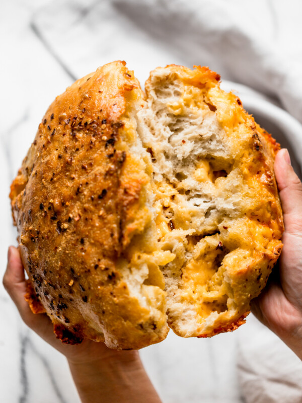 a foolproof recipe for making no-knead spicy cheese bread at home in a dutch oven like a pro! no-knead spicy cheese bread is ridiculously easy to make (only 10 minutes of prep & 5 ingredients needed!), & it’s especially ridiculously easy to eat. great with soup, chili, to serve at a tailgate party, or just as a snack! #playswellwithbutter #nokneadbread #cheesebread #easybreadrecipe #dutchovenbread #stellascheesebread #spicycheesebread #wisconsinrecipe