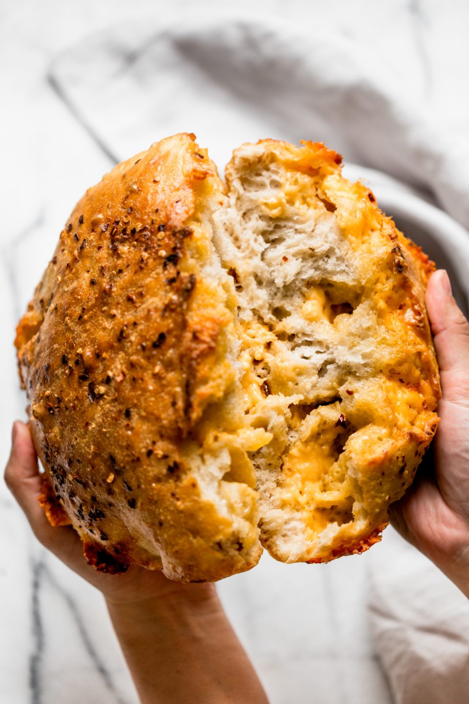 a foolproof recipe for making no-knead spicy cheese bread at home in a dutch oven like a pro! no-knead spicy cheese bread is ridiculously easy to make (only 10 minutes of prep & 5 ingredients needed!), & it’s especially ridiculously easy to eat. great with soup, chili, to serve at a tailgate party, or just as a snack! #playswellwithbutter #nokneadbread #cheesebread #easybreadrecipe #dutchovenbread #stellascheesebread #spicycheesebread #wisconsinrecipe