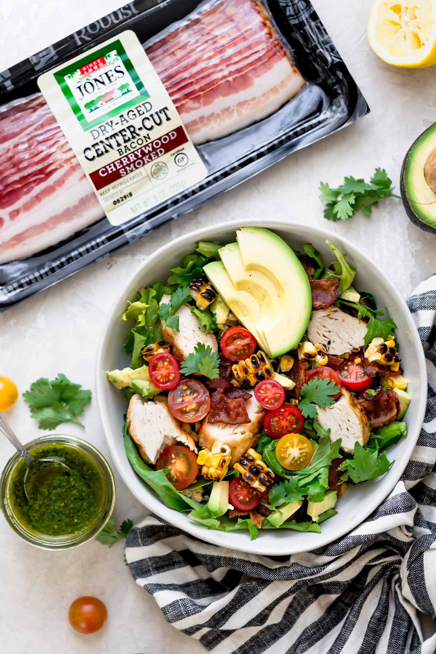 a light & fresh blt salad for summer loaded with bacon, cherry tomatoes, sweet corn, avocados, grilled chicken, & an easy cilantro basil vinaigrette. this blt salad recipe is hearty, but super fresh, making it the perfect easy summer dinner. naturally gluten-free & perfect for meal prep! #playswellwithbutter #bltsalad #saladrecipe #dinnersalad #summersalad #glutenfree #easyglutenfreerecipes