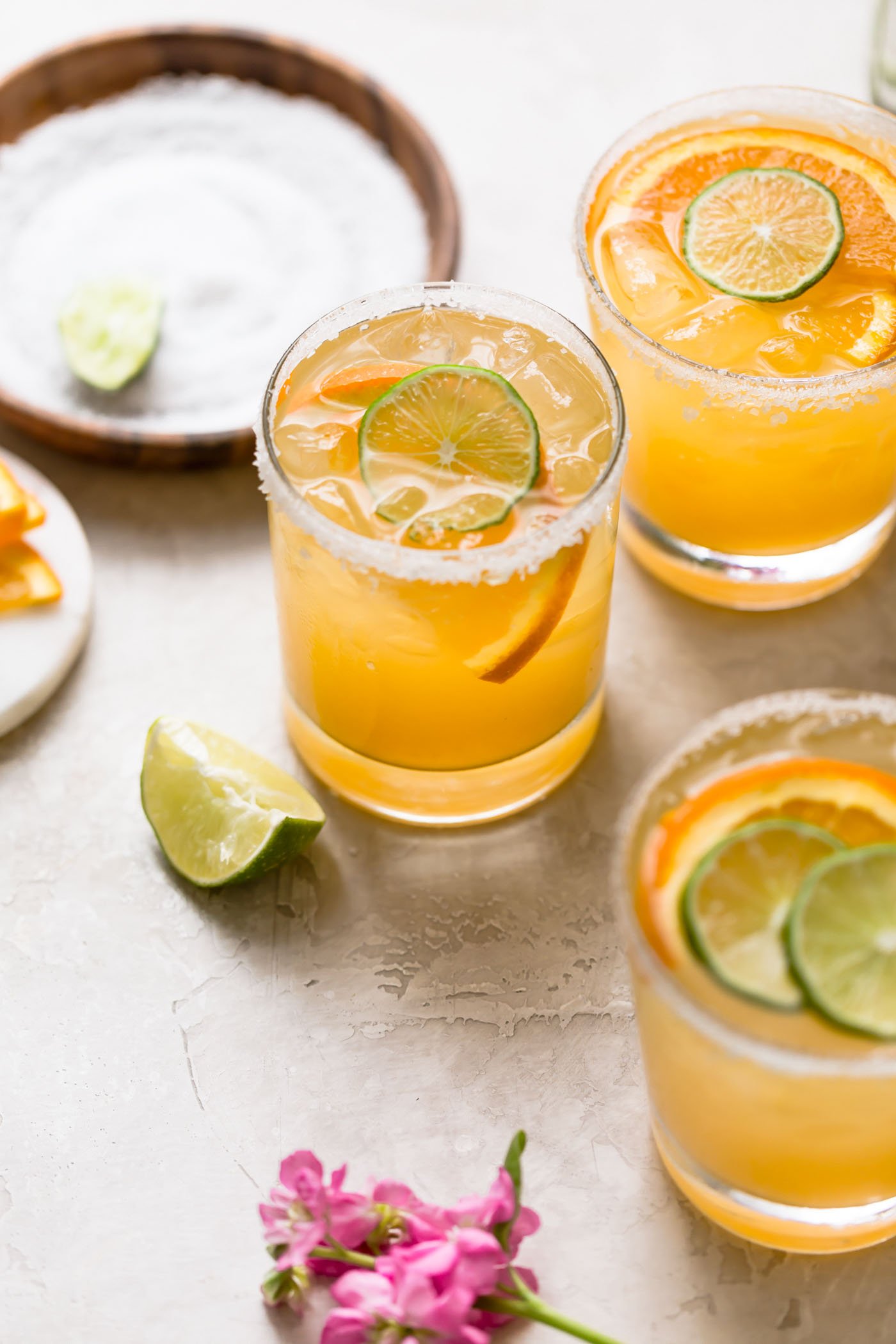 refined sugar-free margaritas are the perfect light & refreshing cocktail! this simple margarita recipe is made without triple sec, using the freshest ingredients instead: fresh lime juice & fresh orange juice, with a little maple syrup to sweeten things up slightly. a modern take on the skinny margarita and a classic margarita on the rocks, say hello to the best margarita recipe & get those chips & guac ready!!! #playswellwithbutter #classicmargaritarecipe #skinnymargaritarecipe #refinedsugarfreerecipes #margaritaontherocks #tequila #maplesyrup #summercocktail #easycocktail