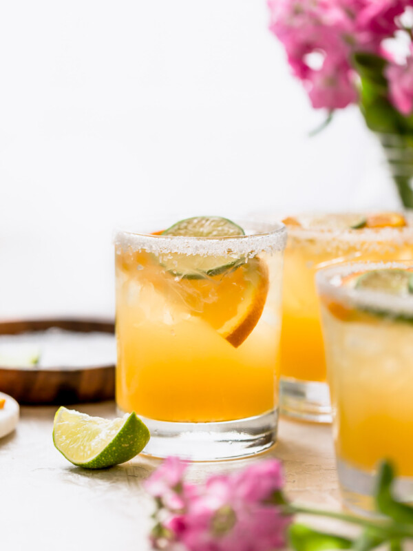 refined sugar-free margaritas are the perfect light & refreshing cocktail! this simple margarita recipe is made without triple sec, using the freshest ingredients instead: fresh lime juice & fresh orange juice, with a little maple syrup to sweeten things up slightly. a modern take on the skinny margarita and a classic margarita on the rocks, say hello to the best margarita recipe & get those chips & guac ready!!! #playswellwithbutter #classicmargaritarecipe #skinnymargaritarecipe #refinedsugarfreerecipes #margaritaontherocks #tequila #maplesyrup #summercocktail #easycocktail
