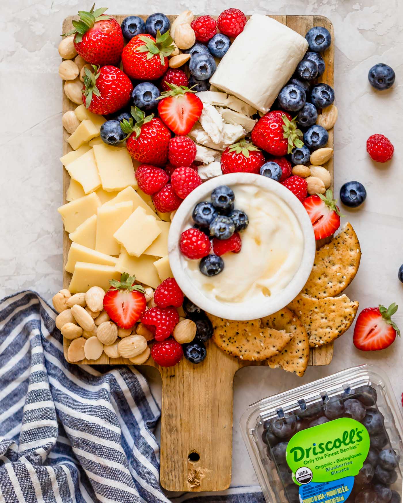 a summer berry cheese board filled with strawberries, raspberries, blueberries, & the perfect cheeses to pair with cheese boards. this summer berry cheese board is an easy & fun appetizer or snack to serve at parties & barbeques all summer long! #playswellwithbutter #summerberrycheeseboard #cheeseboard #summercheeseboard #cheeseboardidea #appetizer #appetizersforparty #easyappetizers #makeaheadappetizers