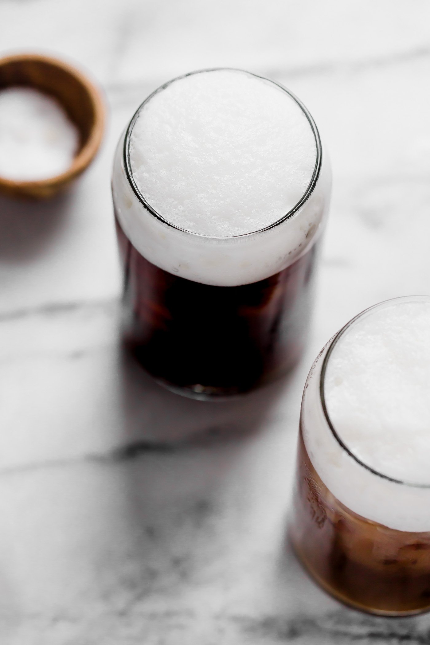 an easy & natural recipe for homemade starbucks salted cream cold foam cold brew with only 4-ingredients! cold brew coffee, lightly sweetened with maple syrup, topped with a creamy salty-sweet cold foam, this salted cream cold foam cold brew coffee is the perfect salty-sweet coffee drink! #playswellwithbutter #saltedcreamcoldfoamcoldbrewcoffee #coldbrew #coldbrewcoffeerecipe #icedcoffee #easycoffeerecipe #starbucksdrinks #starbucksrecipe