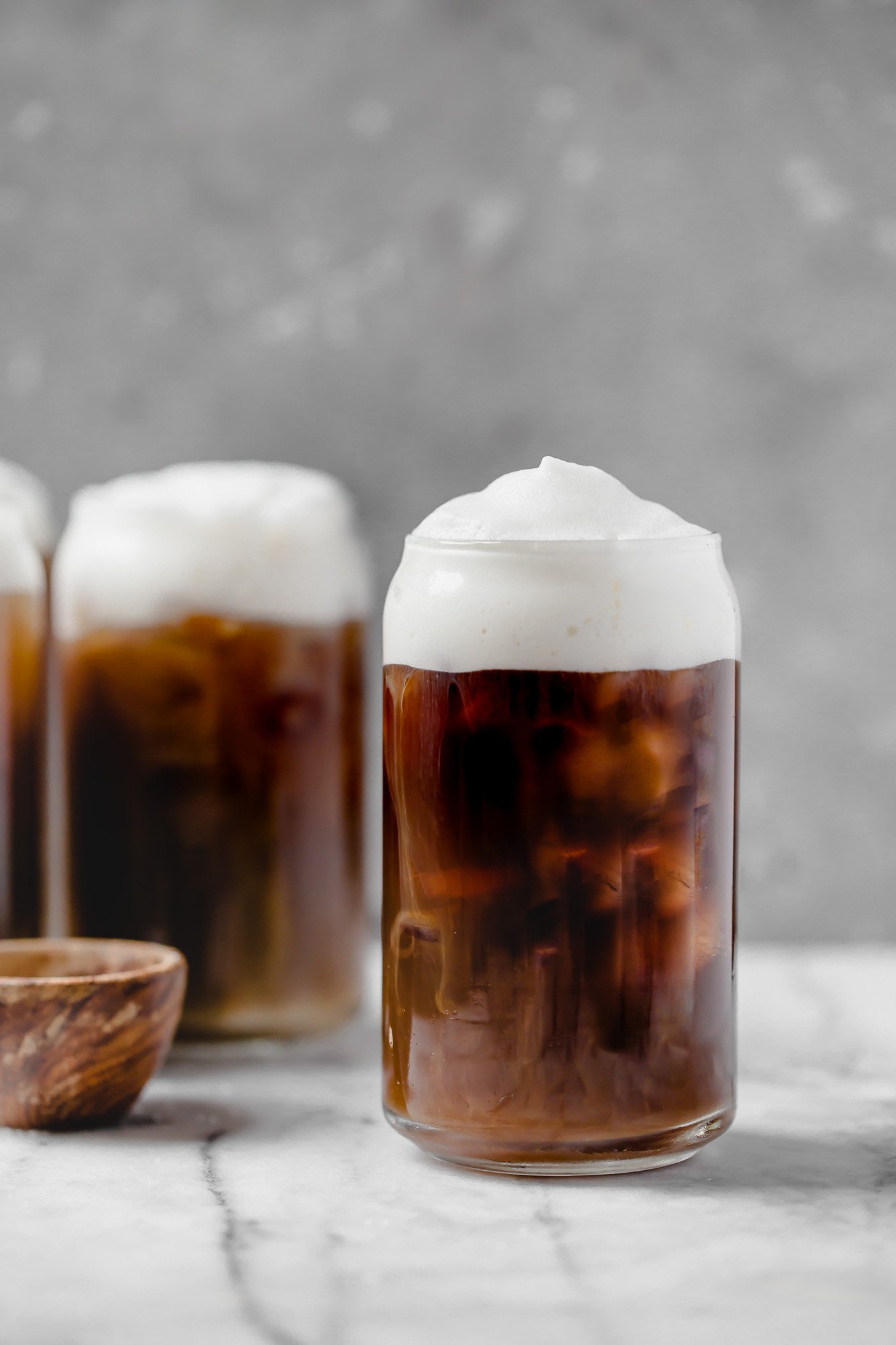 an easy & natural recipe for homemade starbucks salted cream cold foam cold brew with only 4-ingredients! cold brew coffee, lightly sweetened with maple syrup, topped with a creamy salty-sweet cold foam, this salted cream cold foam cold brew coffee is the perfect salty-sweet coffee drink! #playswellwithbutter #saltedcreamcoldfoamcoldbrewcoffee #coldbrew #coldbrewcoffeerecipe #icedcoffee #easycoffeerecipe #starbucksdrinks #starbucksrecipe