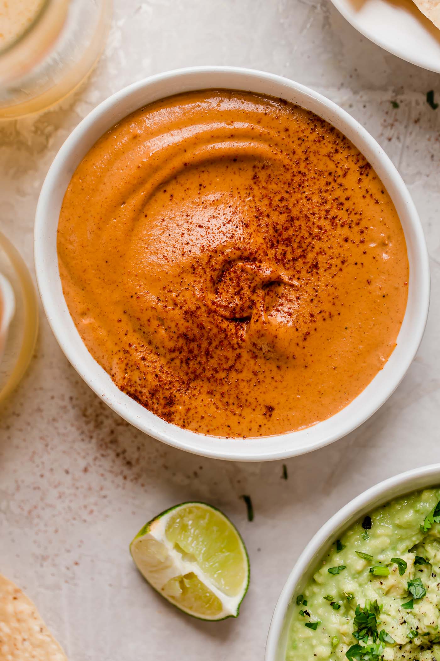 smoky chipotle cashew queso! an easy vegan queso recipe made with cashews, chipotle peppers, spices, & lime juice! the perfect healthy game day snack, smoky chipotle cashew queso will be the hit of your next game day party! #playswellwithbutter #cashewqueso #veganqueso #easyveganrecipes #vegansnack #gamedaysnacks #gamedayappetizer #gamedayfood #healthysnack