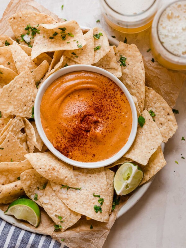 smoky chipotle cashew queso! an easy vegan queso recipe made with cashews, chipotle peppers, spices, & lime juice! the perfect healthy game day snack, smoky chipotle cashew queso will be the hit of your next game day party! #playswellwithbutter #cashewqueso #veganqueso #easyveganrecipes #vegansnack #gamedaysnacks #gamedayappetizer #gamedayfood #healthysnack