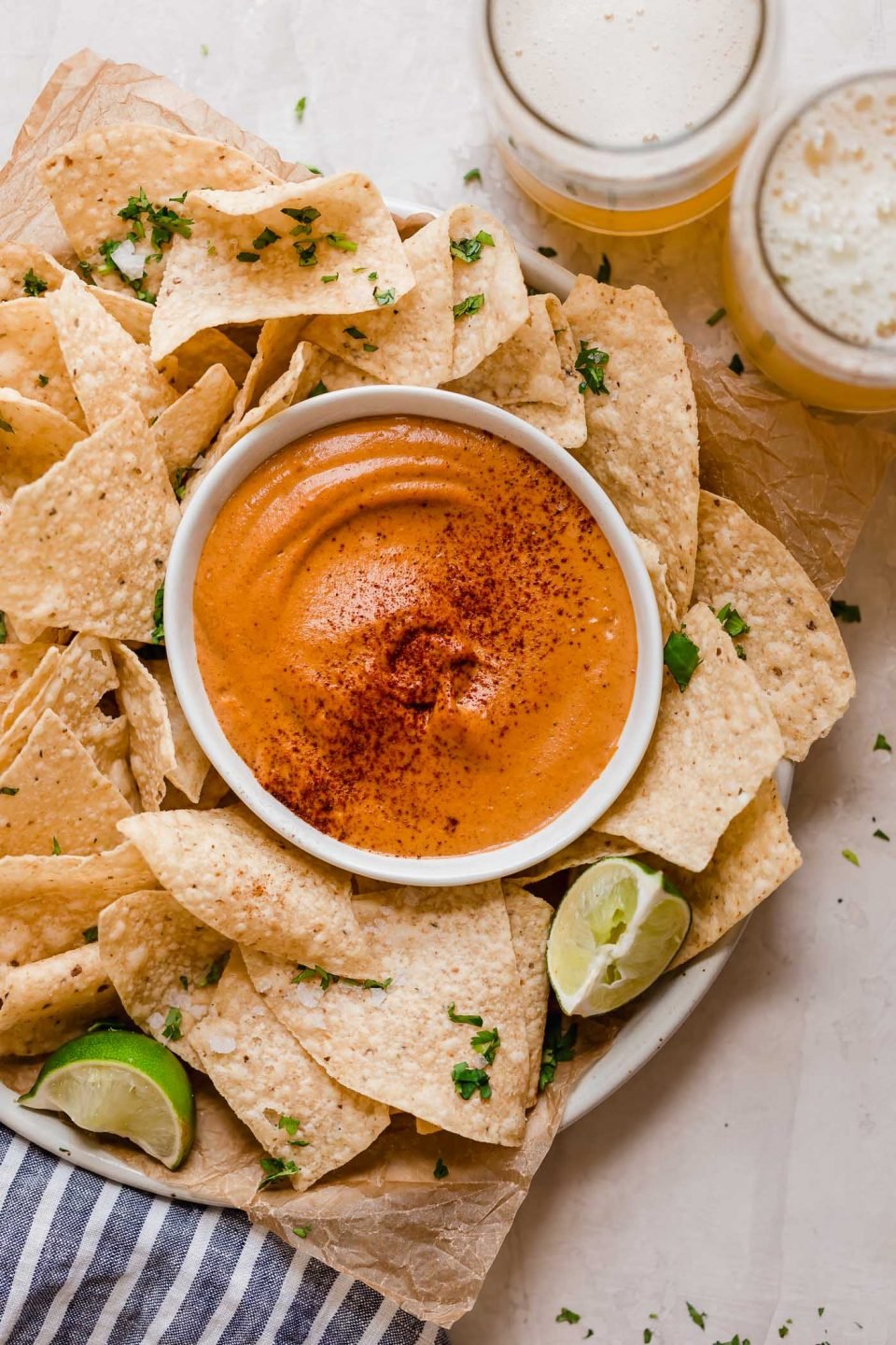 smoky chipotle cashew queso! an easy vegan queso recipe made with cashews, chipotle peppers, spices, & lime juice! the perfect healthy game day snack, smoky chipotle cashew queso will be the hit of your next game day party! #playswellwithbutter #cashewqueso #veganqueso #easyveganrecipes #vegansnack #gamedaysnacks #gamedayappetizer #gamedayfood #healthysnack