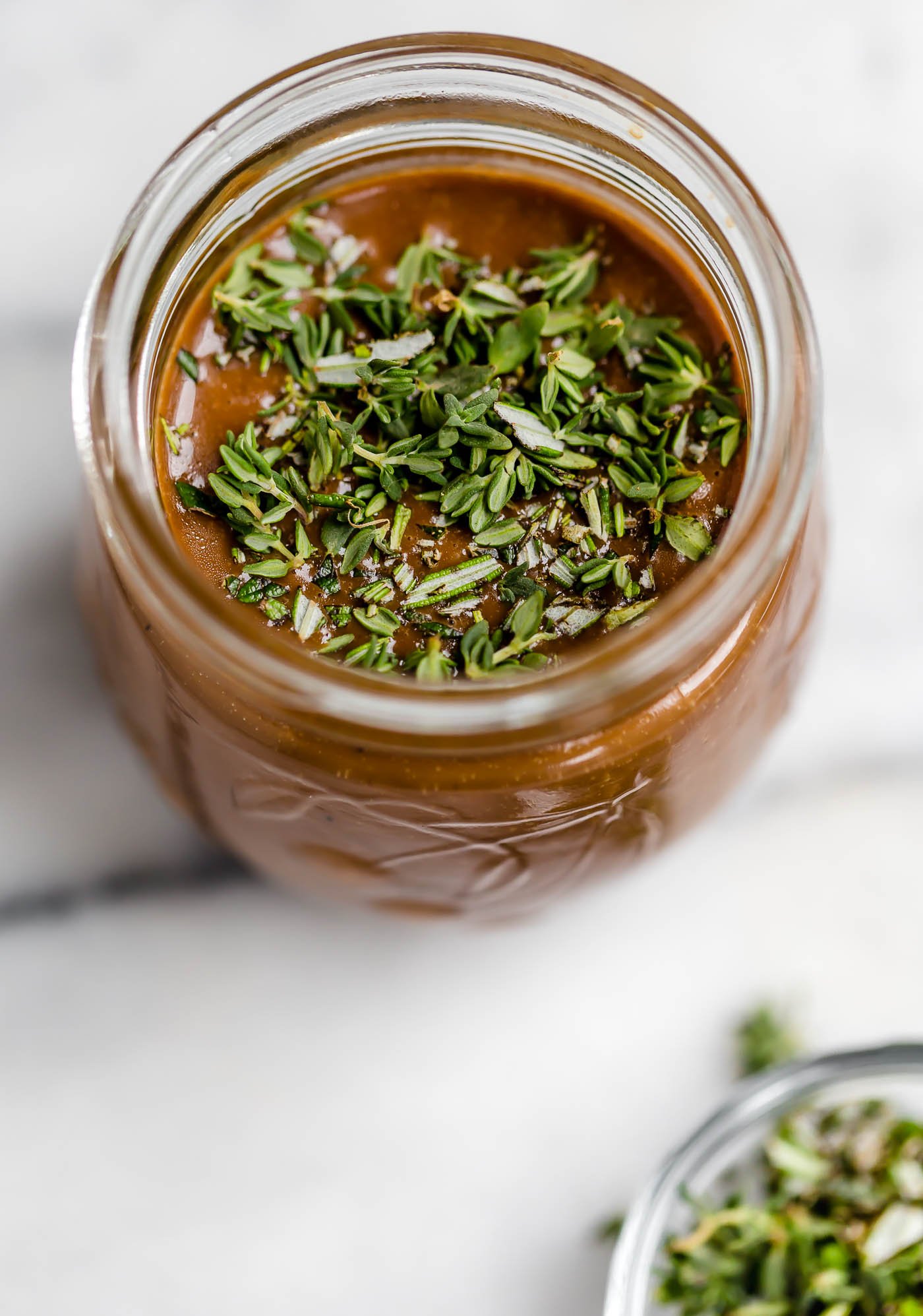 maple balsamic vinaigrette. a simple, but delicious balsamic vinaigrette recipe with pure maple syrup and freshly chopped rosemary & thyme. it takes less than 5 minutes to prep this quick & creamy balsamic vinaigrette, & it’s sure to take any salad to the next level! #playswellwithbutter #balsamicvinaigrette #balsamicvinaigrettedressing #balsamicdressing #saladdressingrecipes #saladdressing #creamybalsamicdressing