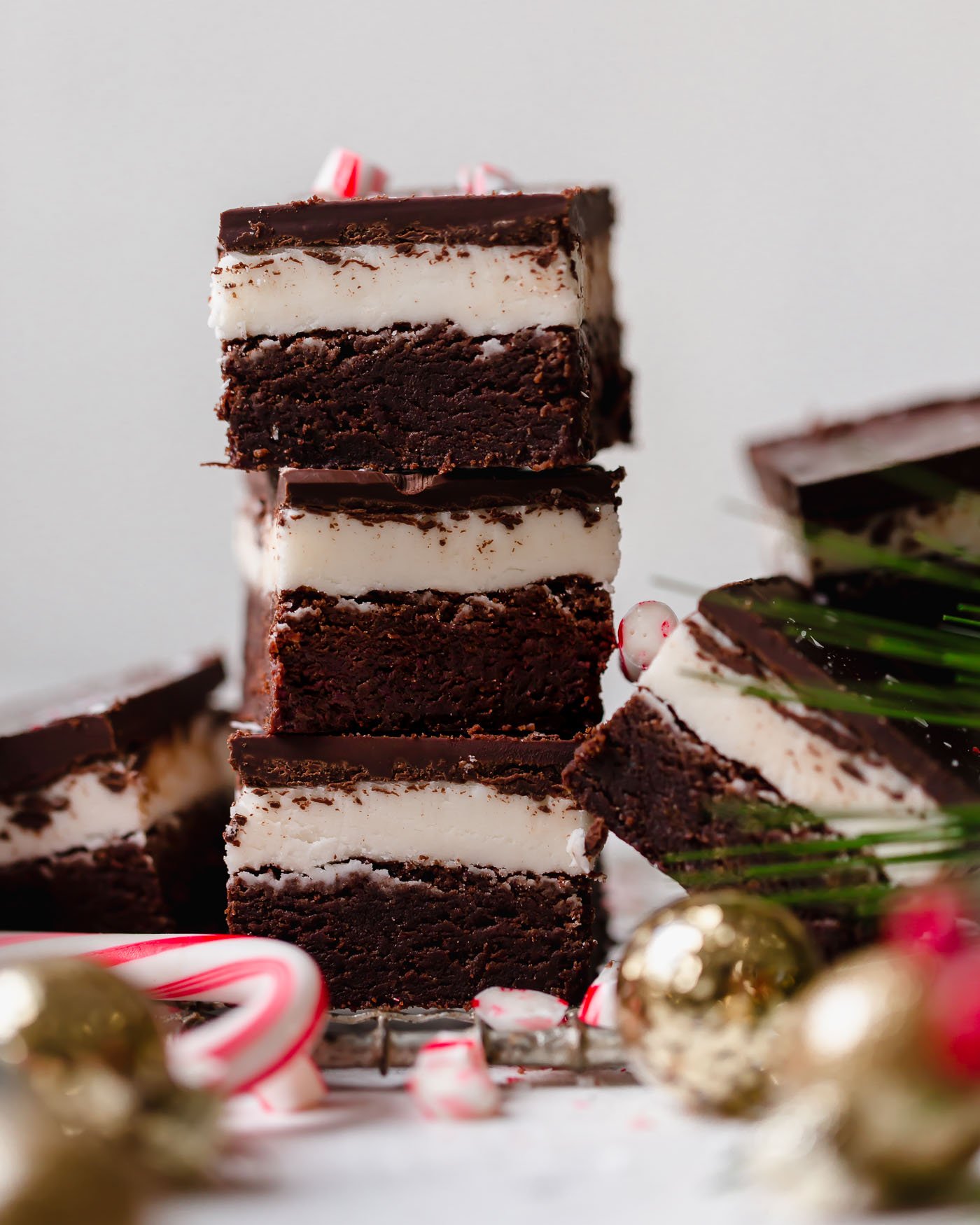 dark chocolate peppermint brownies recipe. extra fudgy dark chocolate brownies topped with homemade peppermint frosting & an easy chocolate glaze. the ultimate easy recipe for a festive holiday dessert! #mintbrowniesrecipe #classicmintbrownies #mintbrowniesfromscratch #mintfrosting #bestmintbrownies #christmascookies #christmasdesserts #darkchocolate #browniesfromscratch #brownieseasy #holidaybaking
