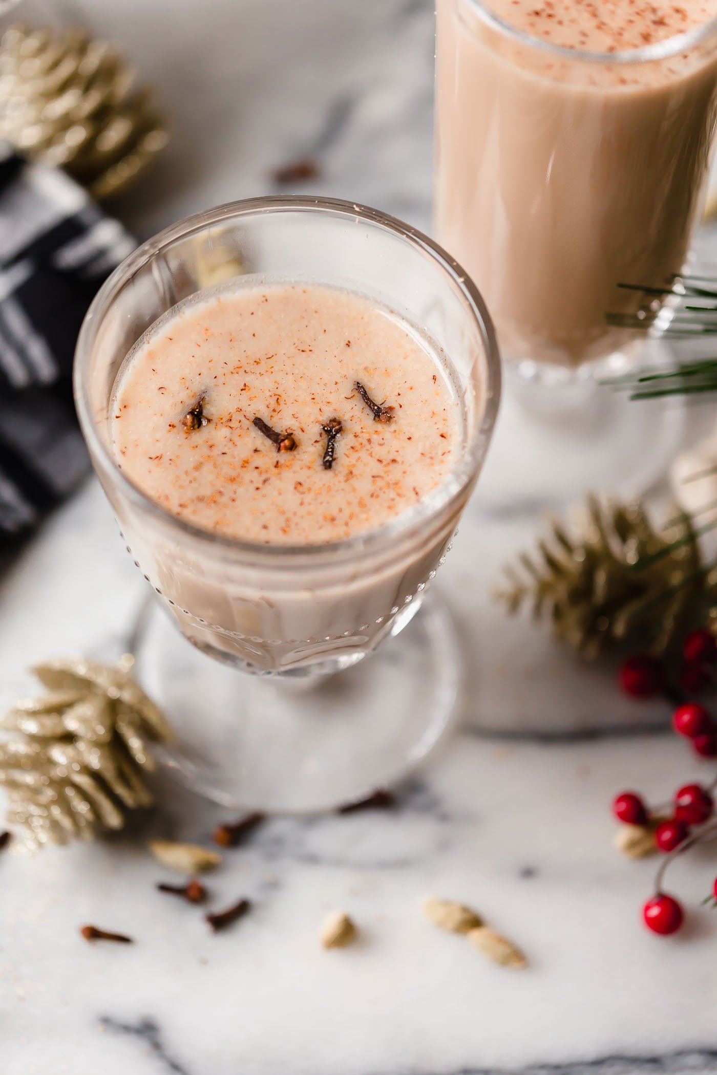 smoky spiked coconut chai tea latte. an easy spiked chai tea recipe! a coconut chai tea latte, lightly sweetened with maple syrup & spiked with mezcal & tequila. an easy & cozy boozy chai tea that’s perfect to warm up on a cold winter night during the holiday season. #playswellwithbutter #spikedchaitea #spikedchailatte #spikedchai #chaicocktail #coconutchai #easycocktailrecipes #fallcocktailrecipes #wintercocktailrecipes #holidaycocktailrecipes #christmascocktailrecipes #mezcalcocktails