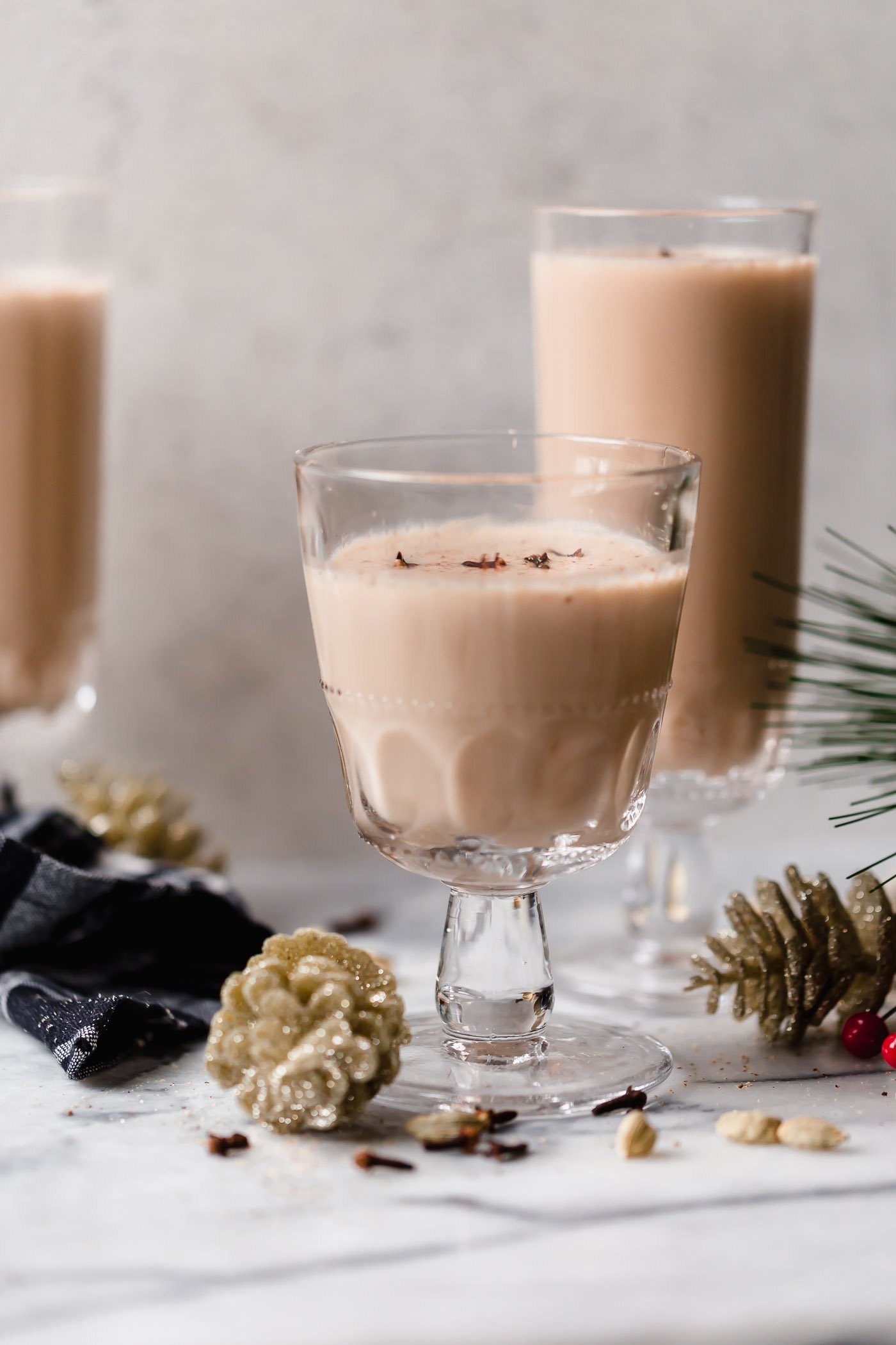 smoky spiked coconut chai tea latte. an easy spiked chai tea recipe! a coconut chai tea latte, lightly sweetened with maple syrup & spiked with mezcal & tequila. an easy & cozy boozy chai tea that’s perfect to warm up on a cold winter night during the holiday season. #playswellwithbutter #spikedchaitea #spikedchailatte #spikedchai #chaicocktail #coconutchai #easycocktailrecipes #fallcocktailrecipes #wintercocktailrecipes #holidaycocktailrecipes #christmascocktailrecipes #mezcalcocktails