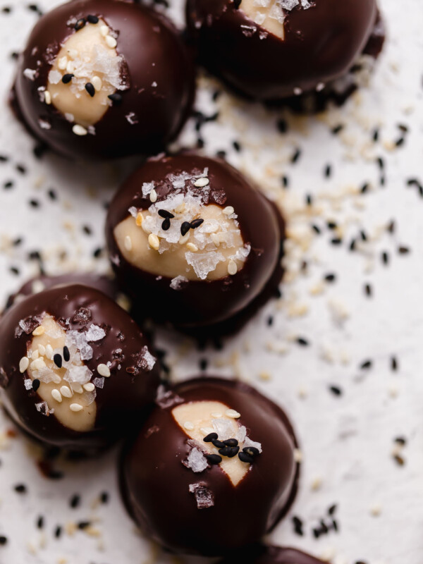 tahini buckeye cookies. everything you love about buckeye balls, with a little modern twist thanks to tahini, or sesame paste. these tahini buckeye cookies are made without peanut butter, making them totally nut-free & allergy friendly. an easy, no-bake cookie recipe to add to your holiday baking list this year!!! #playswellwithbutter #bestbuckeyesrecipe #buckeyeballs #buckeyescookie #buckeyerecipe #tahinirecipe #tahinicookie #nobakecookie #glutenfreedesserts #easychirstmascookie #nutfree