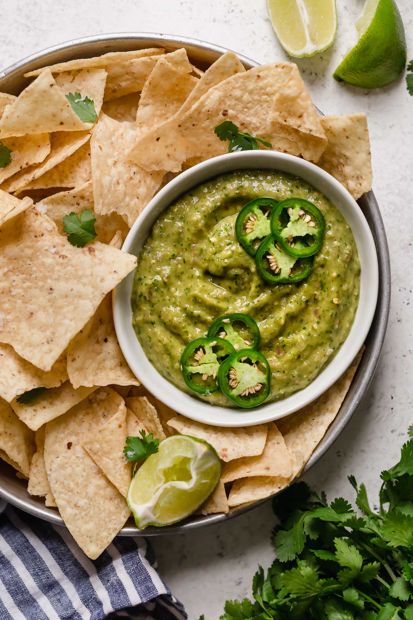 a classic salsa verde recipe with a twist, this creamy salsa verde is full of bright flavors (from tomatillos, peppers, cilantro, & lime juice), & gets tons of creaminess from avocado. this creamy salsa verde recipe is easy to make, & even easier to eat! say hello to your new favorite game day snack! #playswellwithbutter #salsaverde #easysalsaverderecipe #creamysalsaverde #tomatillosalsa #tomatillorecipes #tomatillosauce #easyveganrecipes #vegansnack #gamedaysnacks #gamedayappetizer #gamedayfood