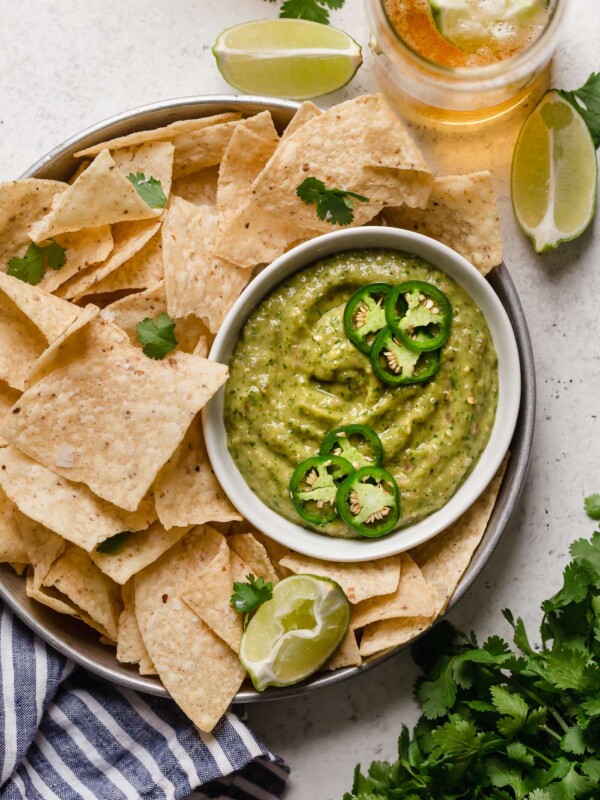 a classic salsa verde recipe with a twist, this creamy salsa verde is full of bright flavors (from tomatillos, peppers, cilantro, & lime juice), & gets tons of creaminess from avocado. this creamy salsa verde recipe is easy to make, & even easier to eat! say hello to your new favorite game day snack! #playswellwithbutter #salsaverde #easysalsaverderecipe #creamysalsaverde #tomatillosalsa #tomatillorecipes #tomatillosauce #easyveganrecipes #vegansnack #gamedaysnacks #gamedayappetizer #gamedayfood
