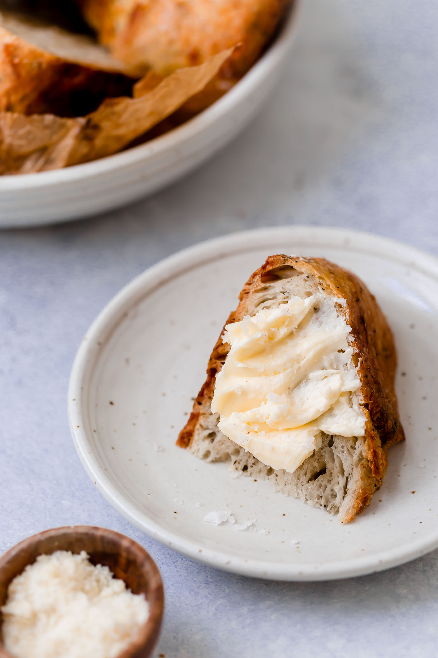 italian herb asiago cheese no-knead bread, prepped in less than 10 minutes active time & baked to crusty, golden perfection in a dutch oven! made with only 5 pantry ingredients, this homemade bread couldn’t be easier to throw together, & is perfect to serve with any of your favorite soups for a totally cozy dinner this winter! #playswellwithbutter #italianherbbread #asiagocheesebread #nokneadbread #nokneadbreaddutchoven #nokneadbreadvariations #easybreadrecipes #crustybread #homemadebread