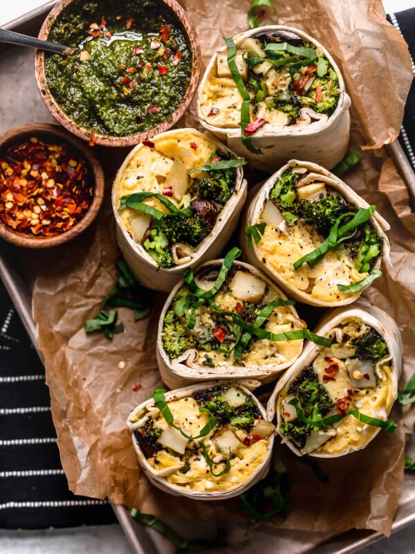 an easy vegetarian breakfast burritos recipe, filled with soft-scrambled eggs, cheese, roasted broccoli, mushrooms & potatoes, & a drizzle of fresh pesto for freshness. pesto roasted veggie vegetarian breakfast burritos are the perfect healthy make-ahead breakfast for weekdays! (meal prep & freezer-friendly) #breakfastburritos #vegetarianbreakfastburritos #easybreakfastburritos #makeaheadbreakfast #freezerbreakfastburritos #breakfastrecipes #makeaheadbreakfastrecipes #easybreakfastrecipes