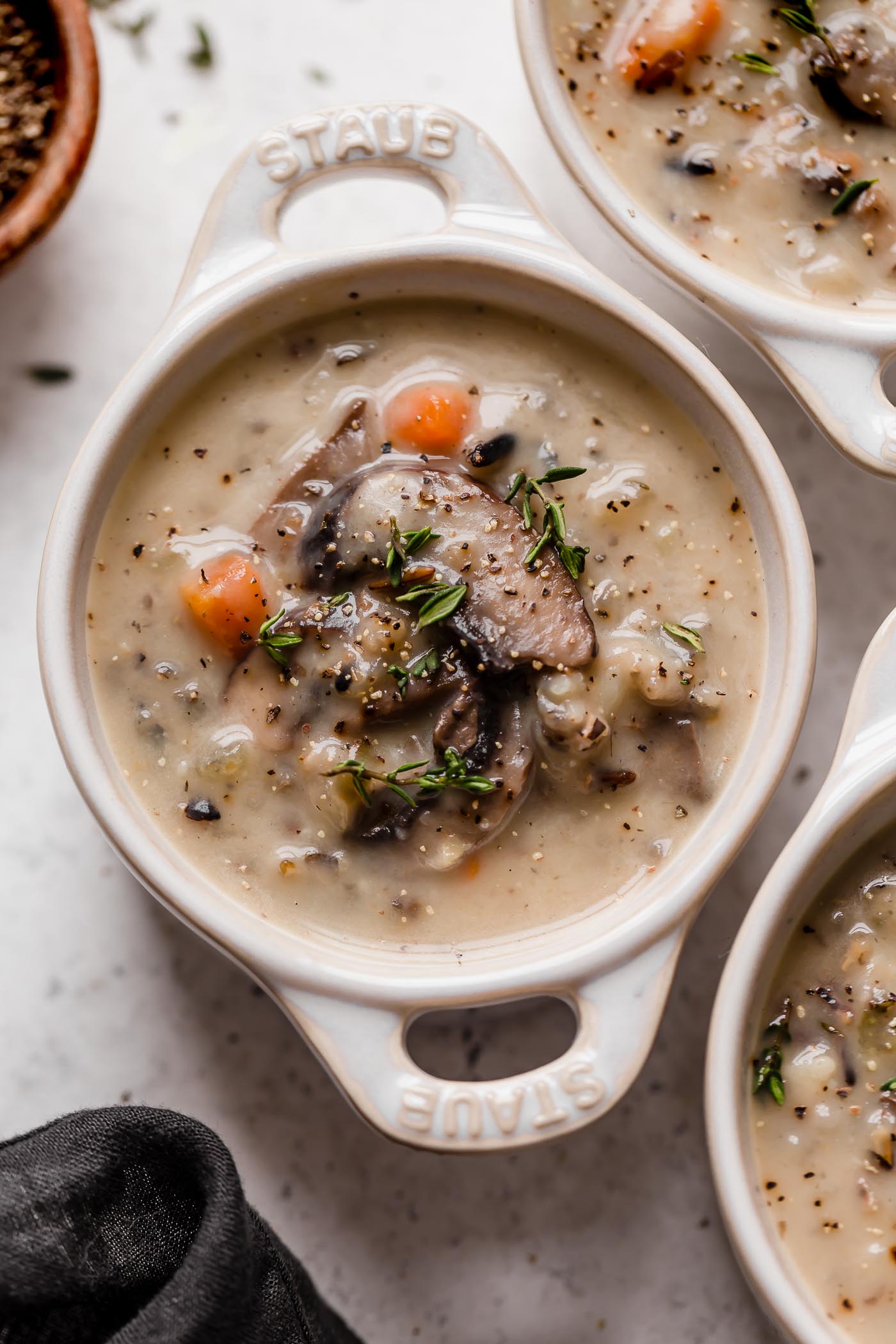 a satisfying vegetarian wild rice soup filled with mushrooms, wild rice, & kale. this creamy wild rice soup is thickened without using any dairy or a flour roux thanks to a totally healthy secret ingredient...cauliflower! {plant-based, vegetarian, vegan, dairy-free, gluten-free} #wildricesoup #vegetarianwildricesoup #mushroomwildricesoup #wildricesouprecipe #dairyfreewildricesoup #souprecipes #healthysoup #veganrecipes #vegansoup #glutenfreerecipes #glutenfreesoup