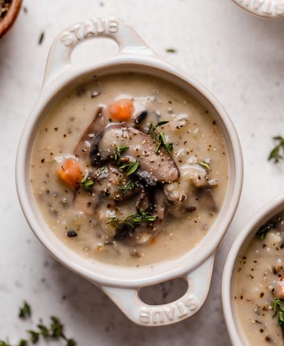 a satisfying vegetarian wild rice soup filled with mushrooms, wild rice, & kale. this creamy wild rice soup is thickened without using any dairy or a flour roux thanks to a totally healthy secret ingredient...cauliflower! {plant-based, vegetarian, vegan, dairy-free, gluten-free} #wildricesoup #vegetarianwildricesoup #mushroomwildricesoup #wildricesouprecipe #dairyfreewildricesoup #souprecipes #healthysoup #veganrecipes #vegansoup #glutenfreerecipes #glutenfreesoup