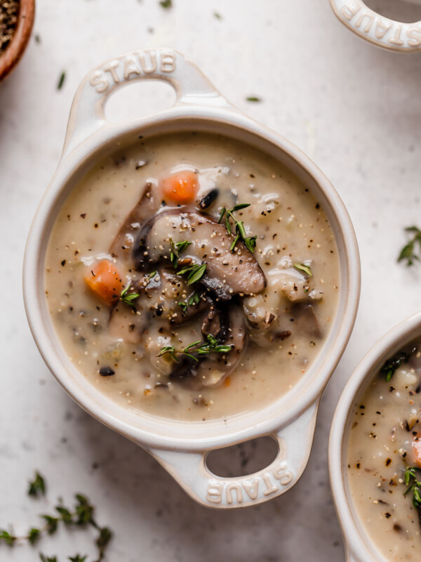 a satisfying vegetarian wild rice soup filled with mushrooms, wild rice, & kale. this creamy wild rice soup is thickened without using any dairy or a flour roux thanks to a totally healthy secret ingredient...cauliflower! {plant-based, vegetarian, vegan, dairy-free, gluten-free} #wildricesoup #vegetarianwildricesoup #mushroomwildricesoup #wildricesouprecipe #dairyfreewildricesoup #souprecipes #healthysoup #veganrecipes #vegansoup #glutenfreerecipes #glutenfreesoup