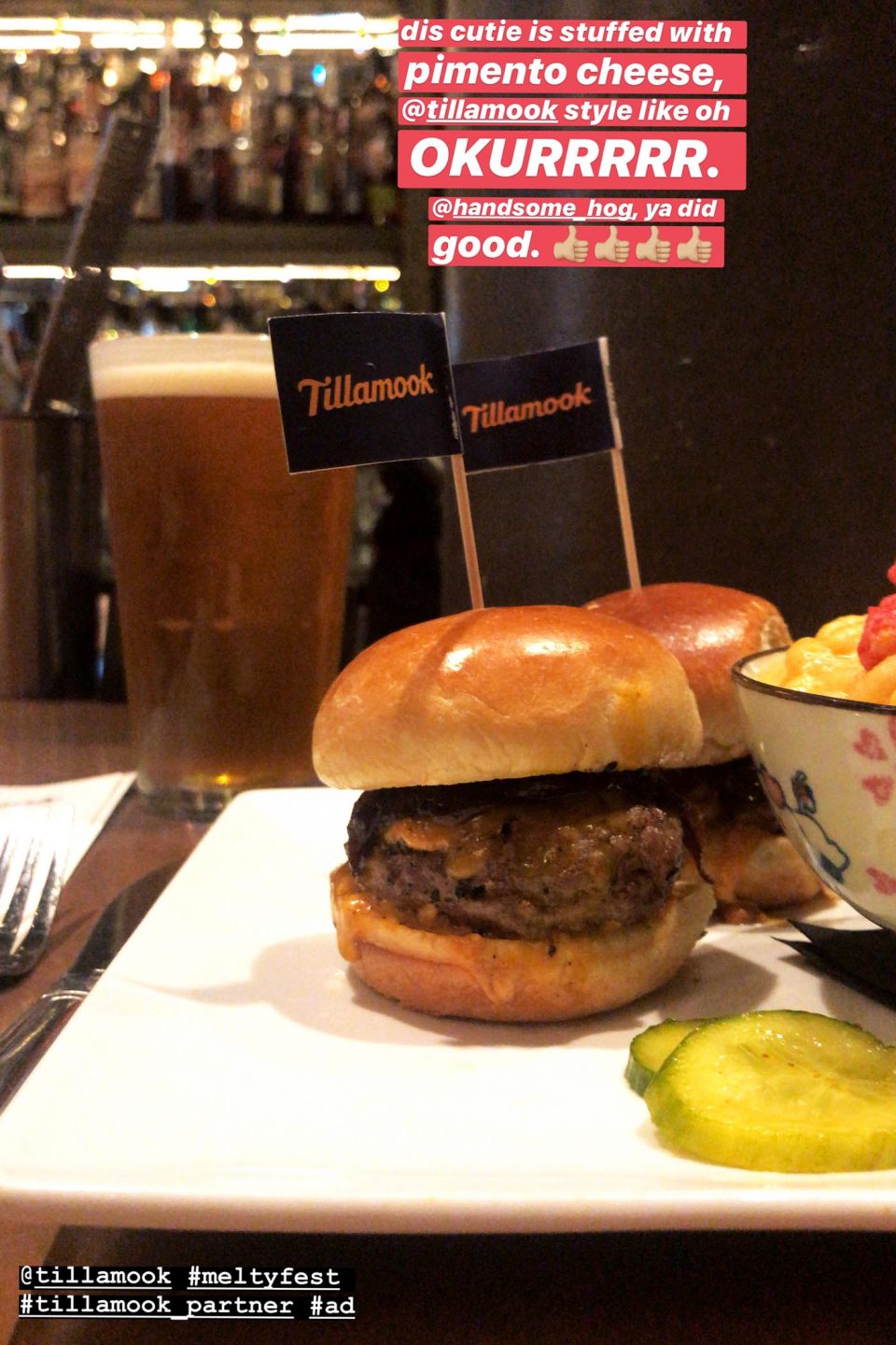 Mini cheeseburger on a plate with mini blue flag that says "Tillamook" coming out of it.