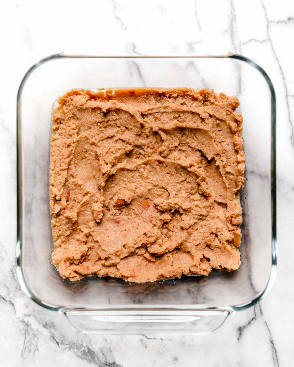 Vegan 7-Layer Dip Recipe Layer #1: Refried Beans or Black Bean Hummus
