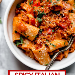 Spicy Italian Sausage & Peppers pasta with graphic text overlay for Pinterest