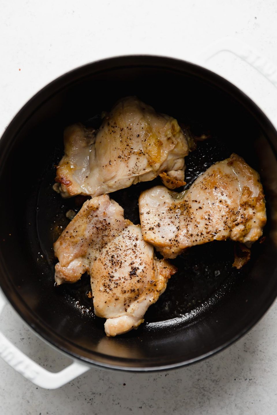 Searing chicken thighs is the first step in this Golden Chicken Soup recipe.
