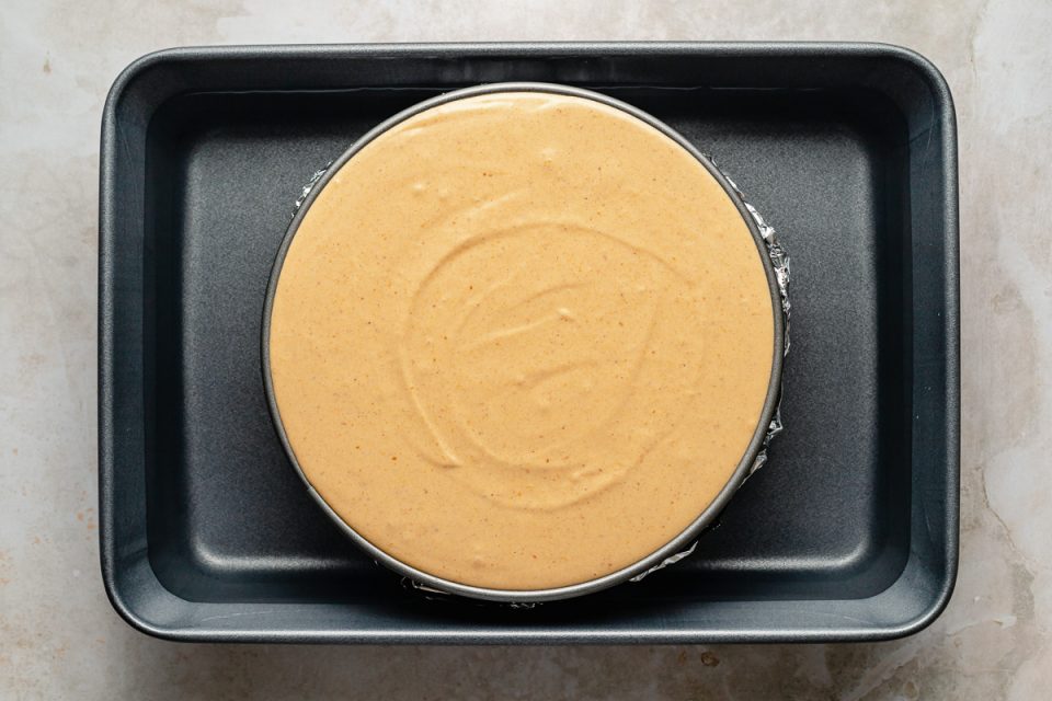 Pumpkin cheesecake, before baking. The cheesecake is assembled in a springform pan, placed in a larger roasting dish for a water batch.