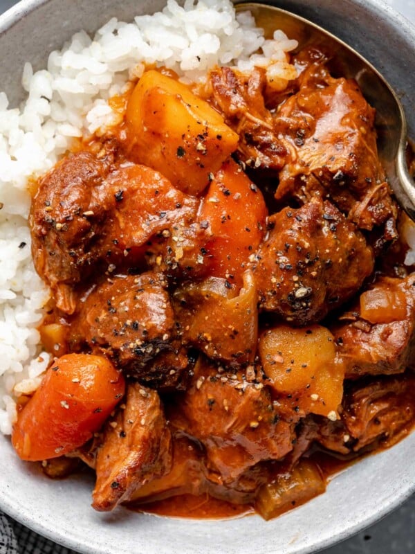 Hawaiian style beef stew over sticky rice in a large bowl.
