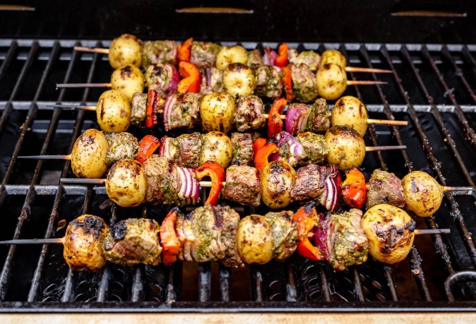 Grilled steak kabobs, Step 4: Grilled steak kabobs shown on grill grates.