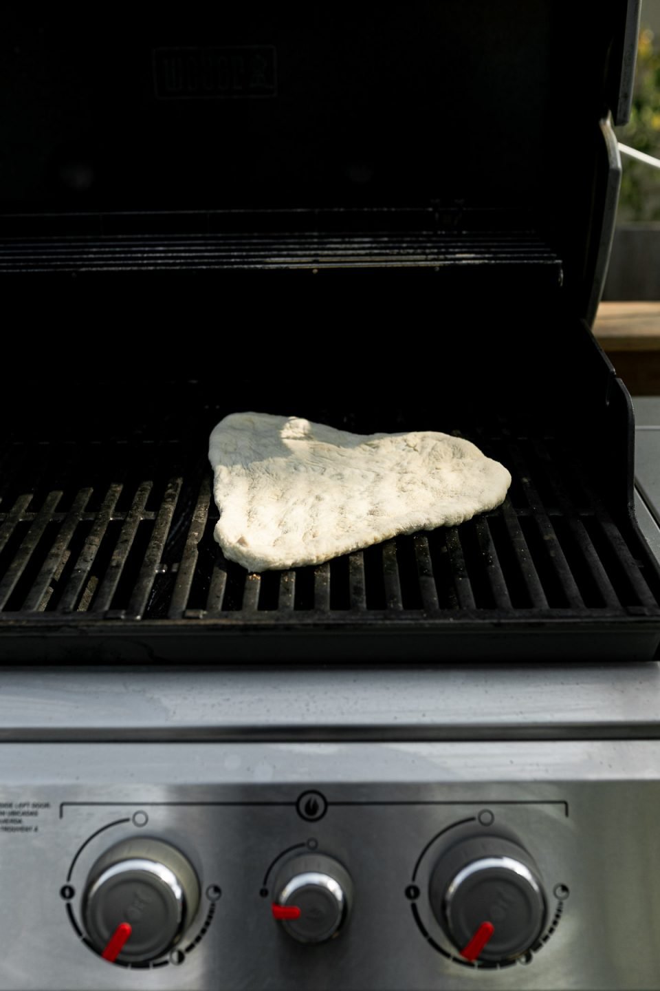 How to grill pizza, Step 4: Par grilled pizza crust on grill grates over direct heat.