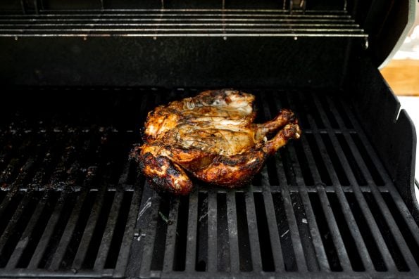 How to grill whole chicken, Step 7: Spatchcocked/butterflied chicken on grill grates, grilling in a direct heat zone of Weber Genesis II grill.